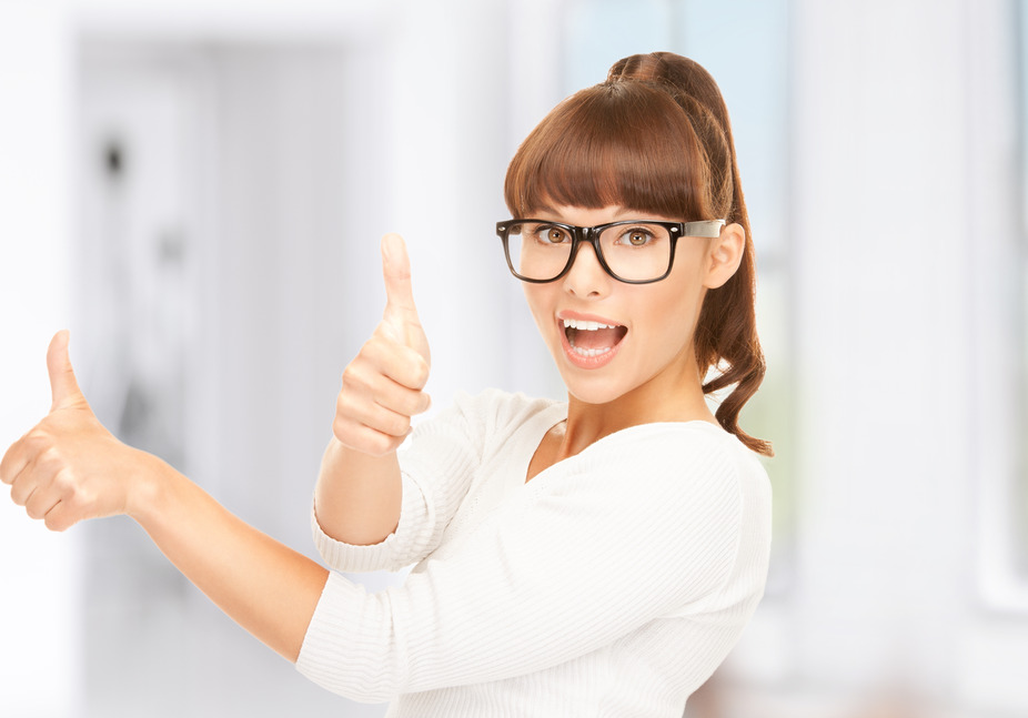 lovely teenage girl with thumbs up wearing glasses